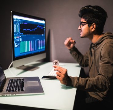 indian-trader-with-bitcoin-checking-stock-trading-data-analysis-concept-working-office-with-financial-graph-computer-monitors 1